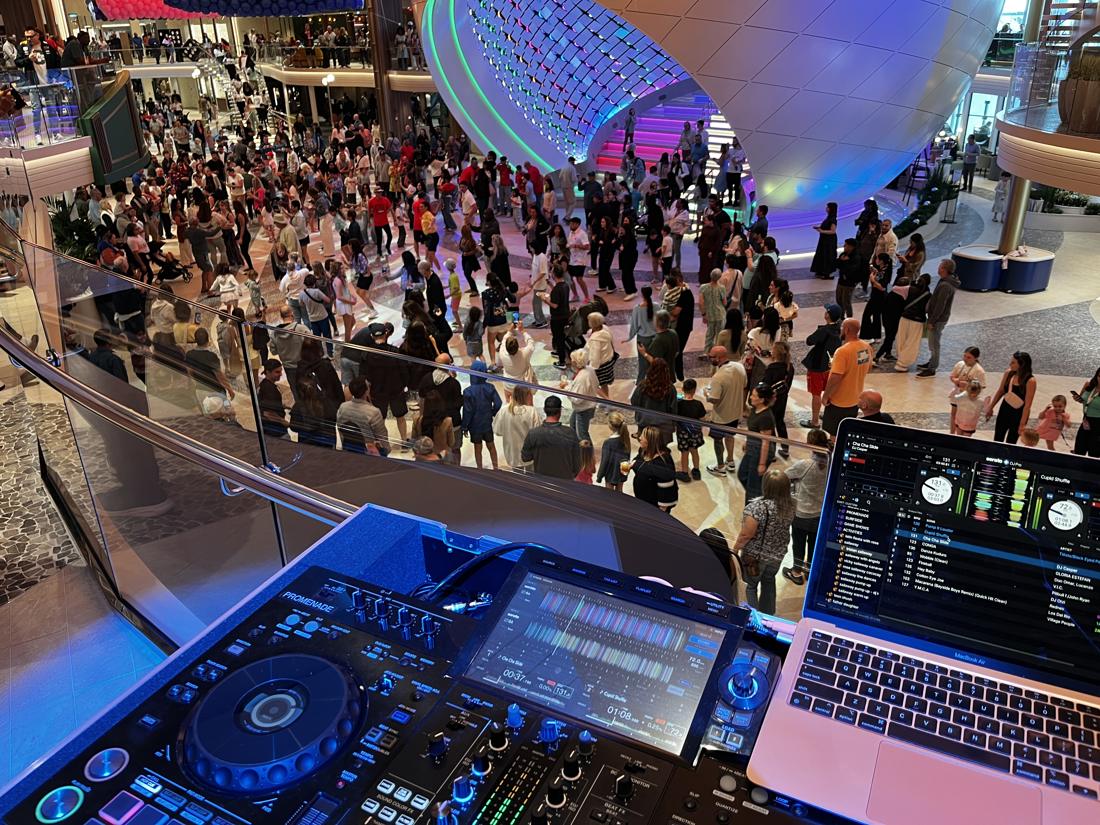 A large crowd doing the Cha Cha Slide in an atrium