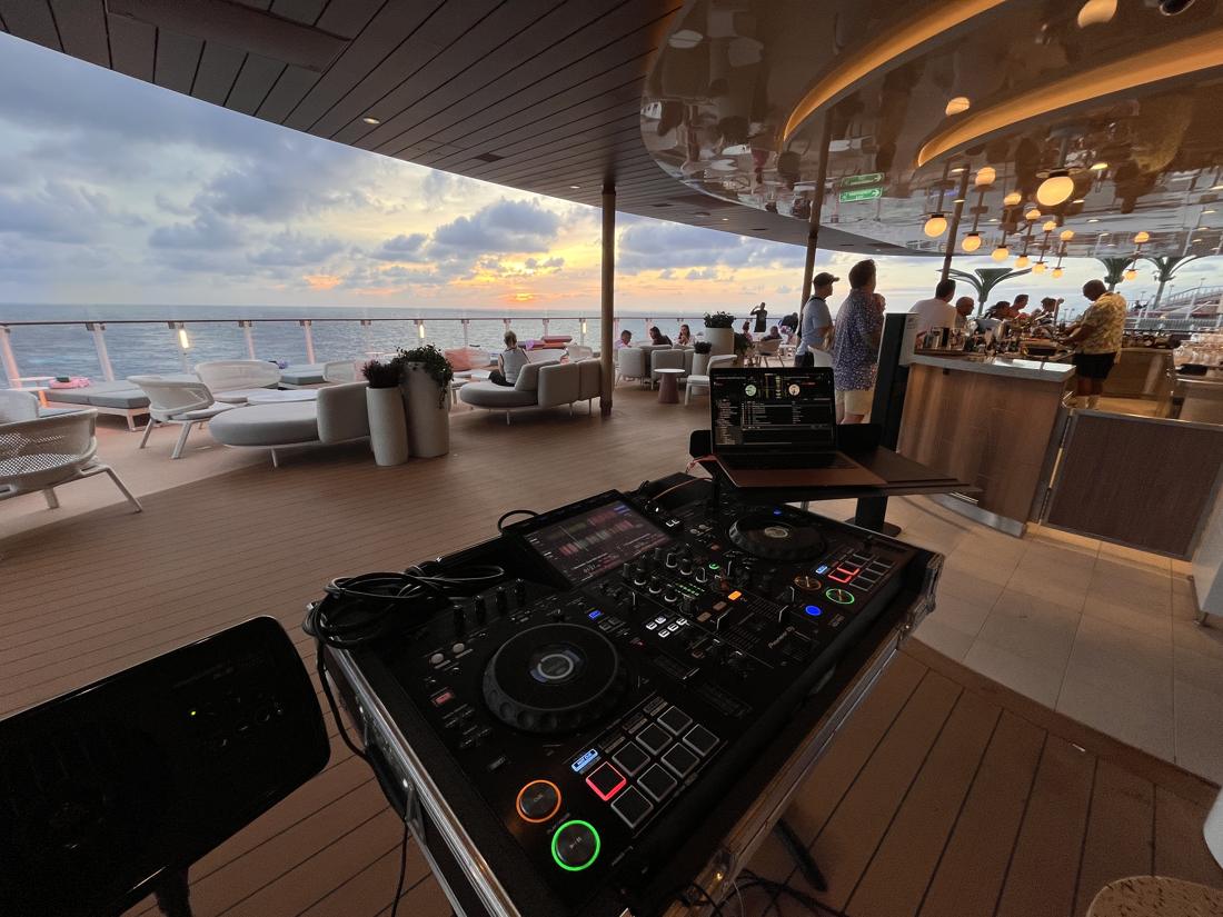 DJ setup on a lounge deck at sunset