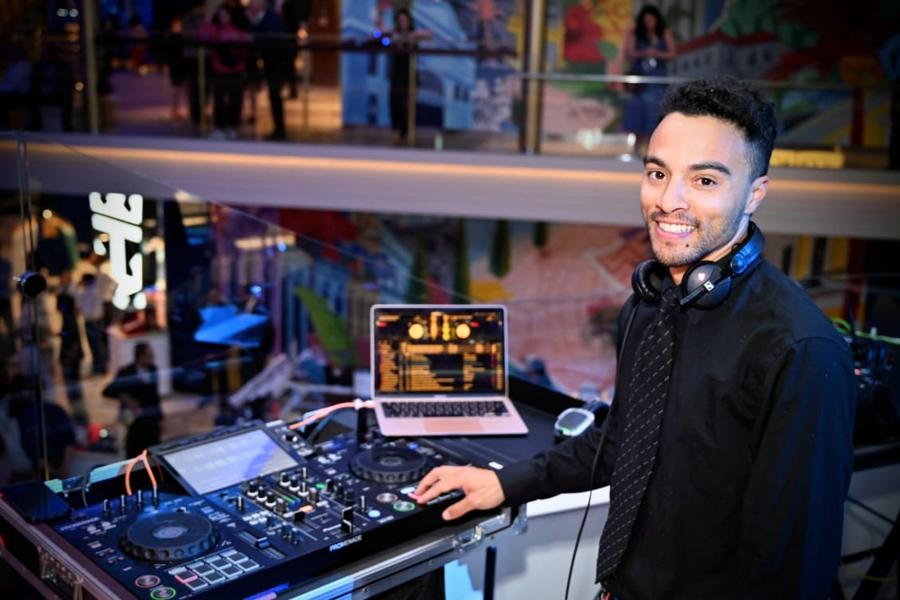 Jordan River smiling behind his DJ setup